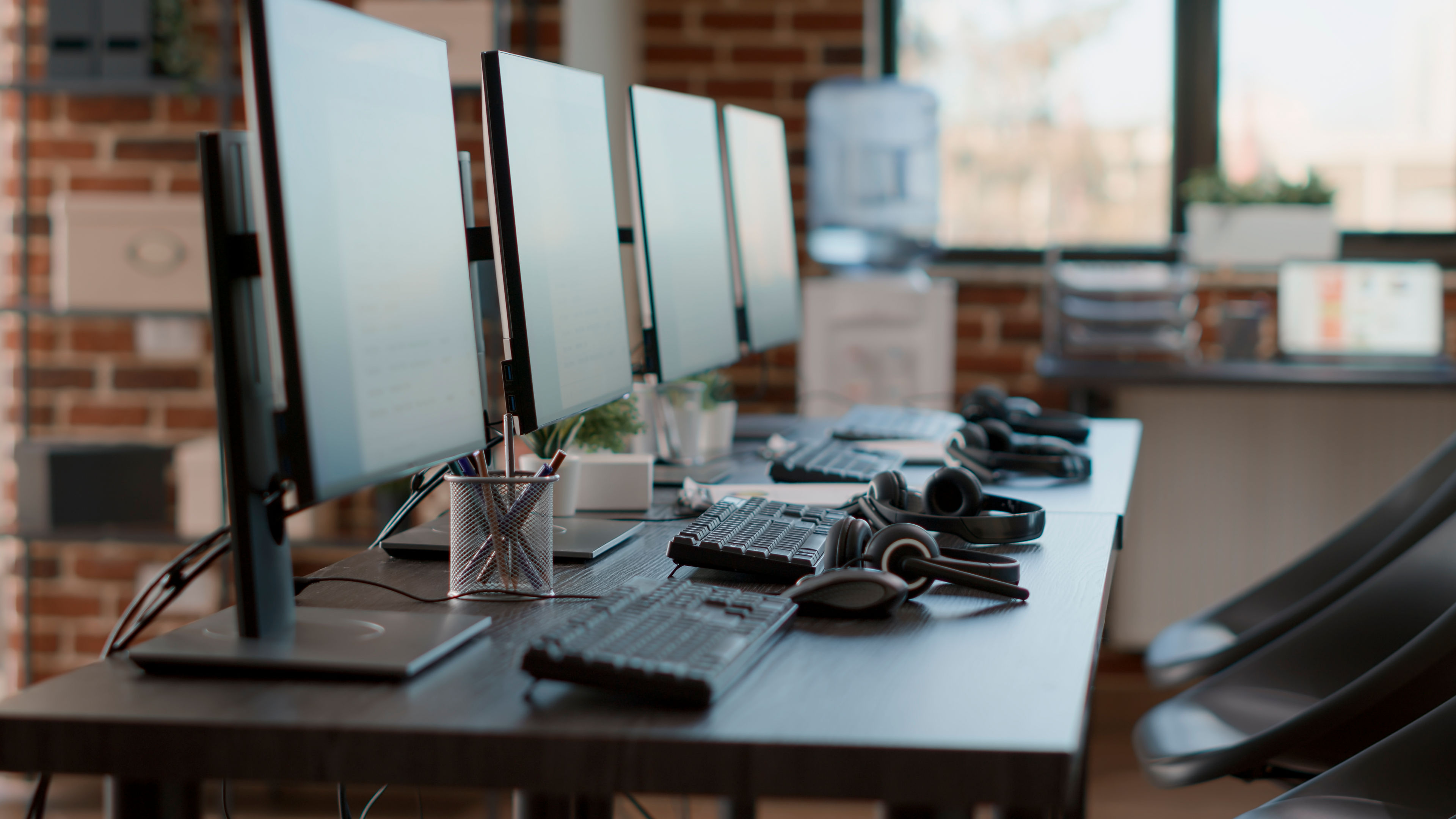 Multiple computers in an empty office setup.