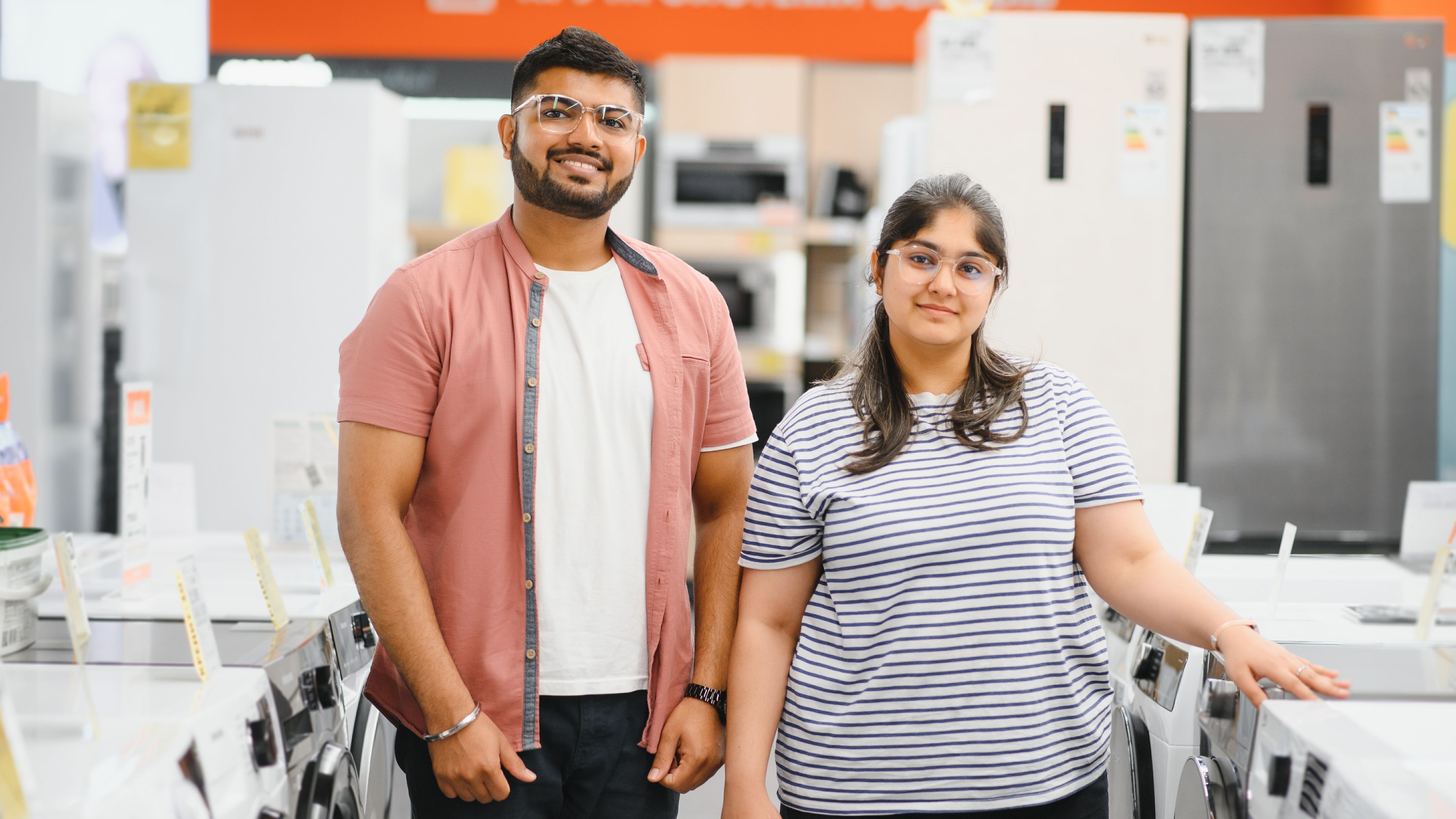 A couple in an  electronics appliance showroom