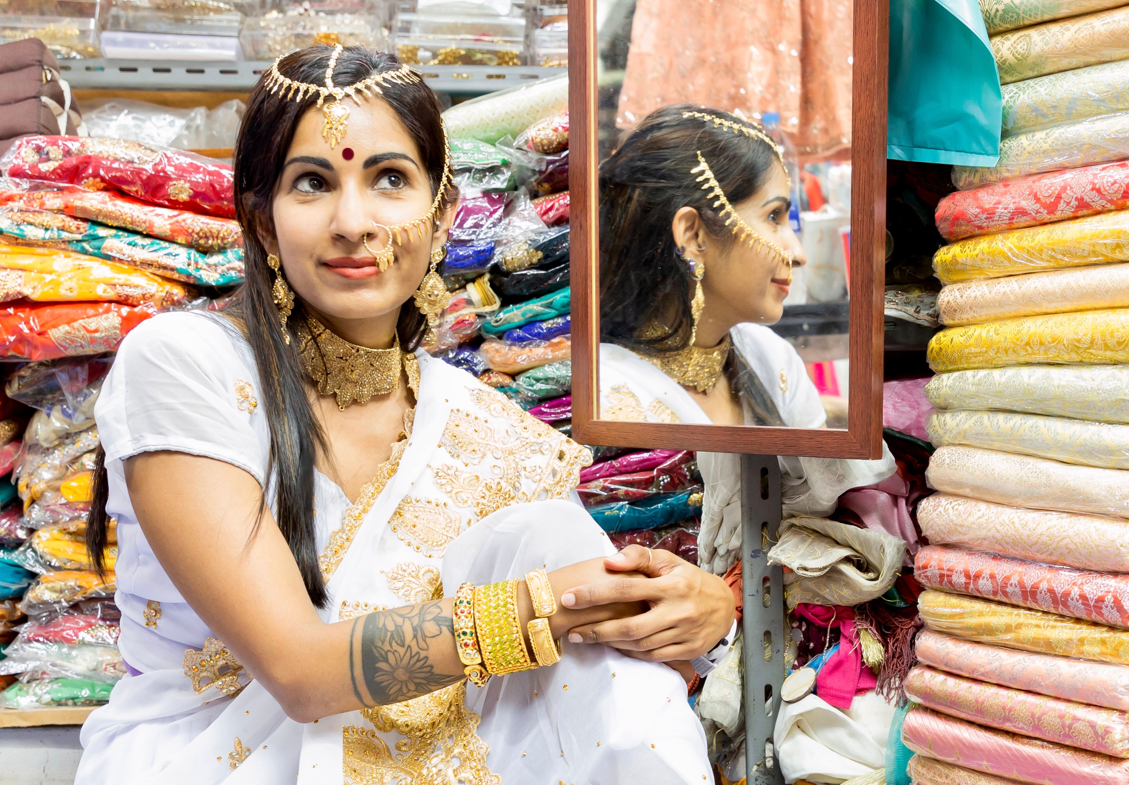 A traditionally dressed Indian woman looking up and smiling