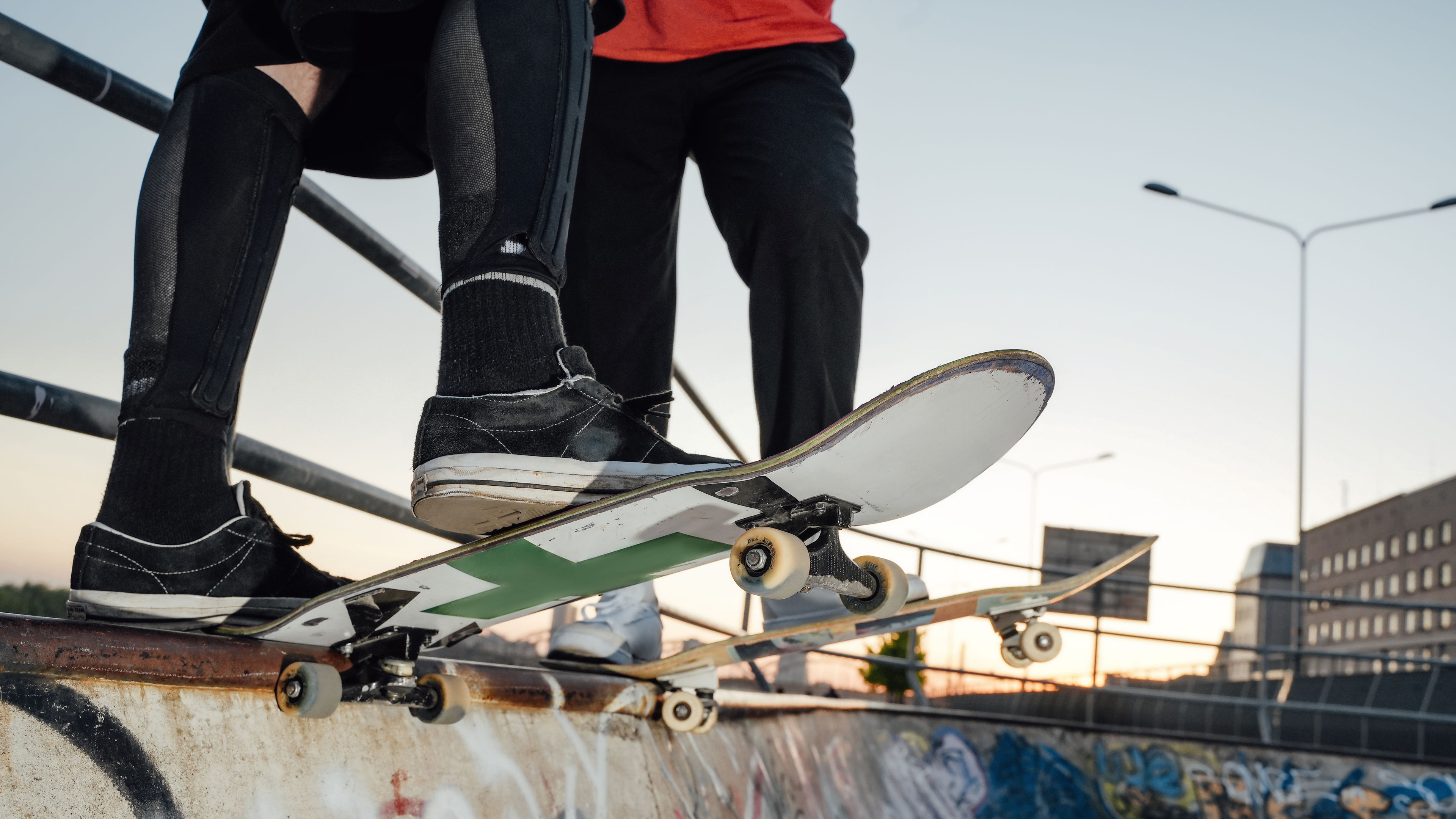 Couple of two skateboarders at skate park together