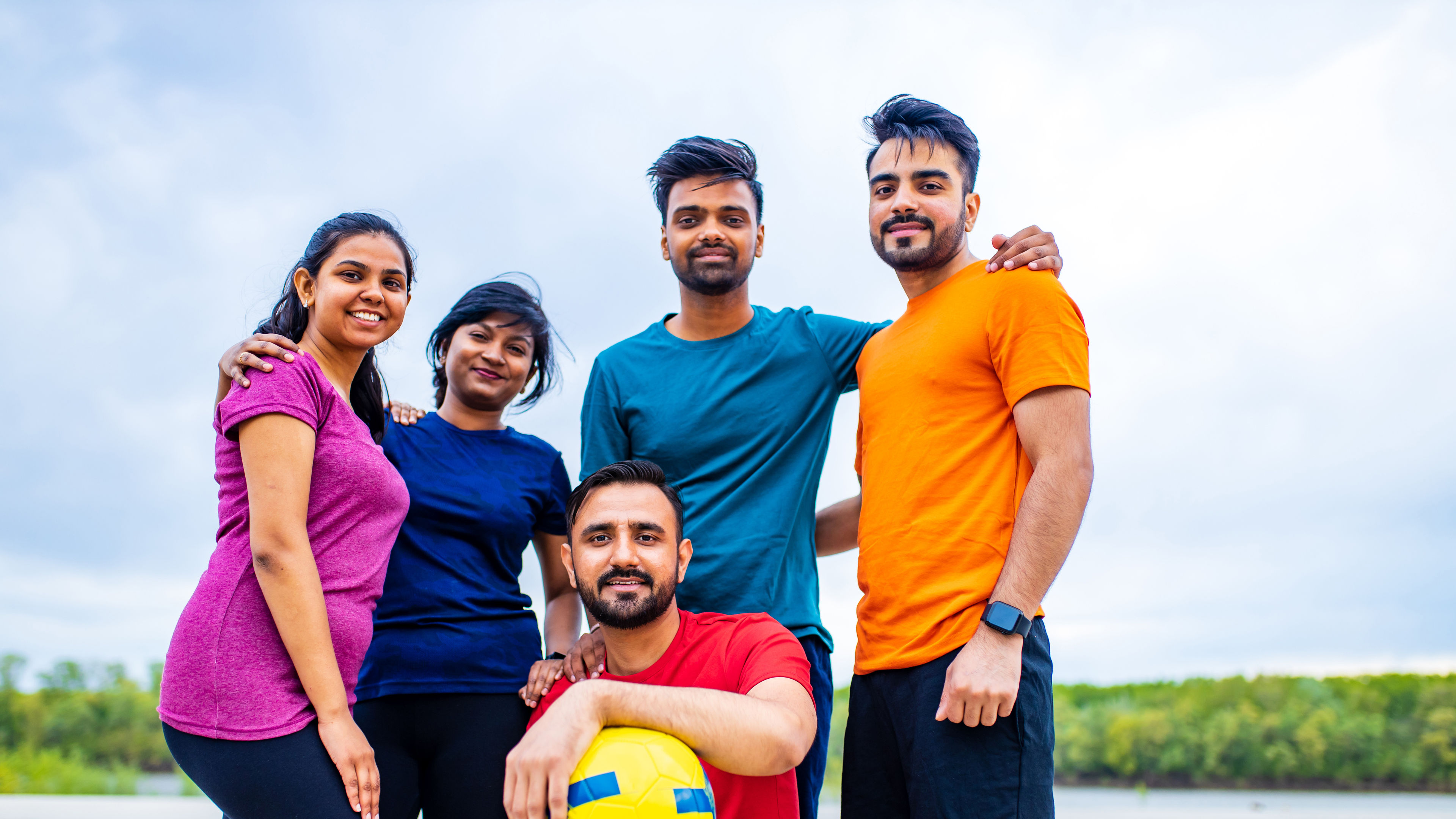 Indian people warming up outdoors in sport wear